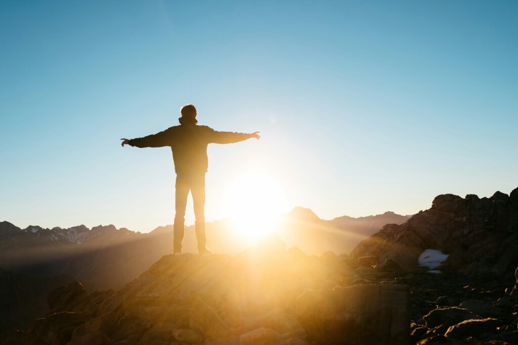 An empowered person standing tall in the sunlight.